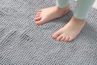 Photo of Girl on soft carpet at home, above view. Space for text