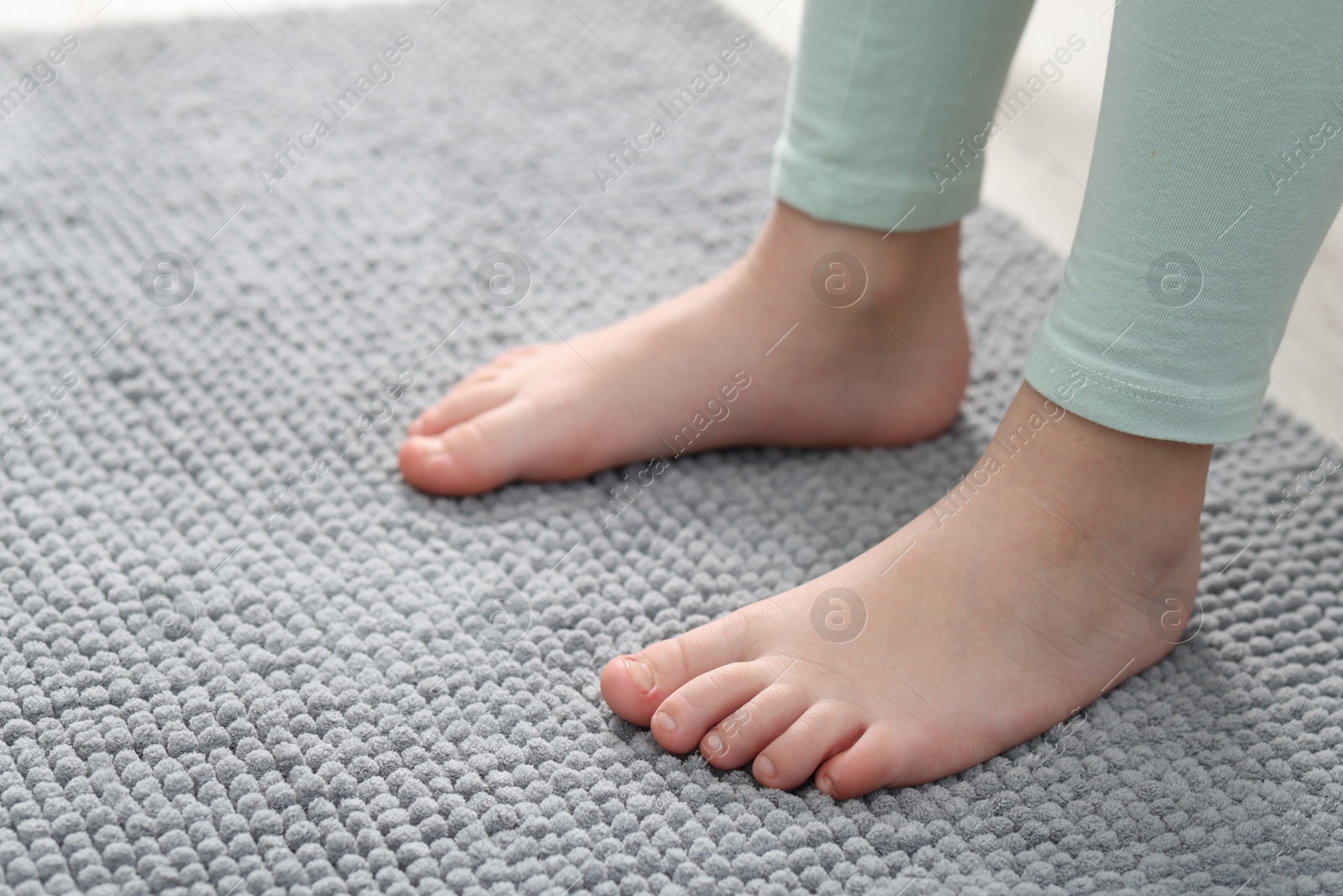 Girl on soft carpet at home, closeup. Space for text Photo of Girl on soft carpet at home, closeup. Space for text