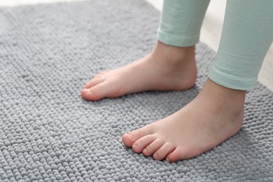 Photo of Girl on soft carpet at home, closeup. Space for text