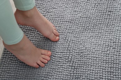 Photo of Girl on soft carpet at home, above view. Space for text