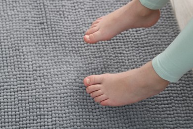 Photo of Girl above soft carpet at home, closeup. Space for text
