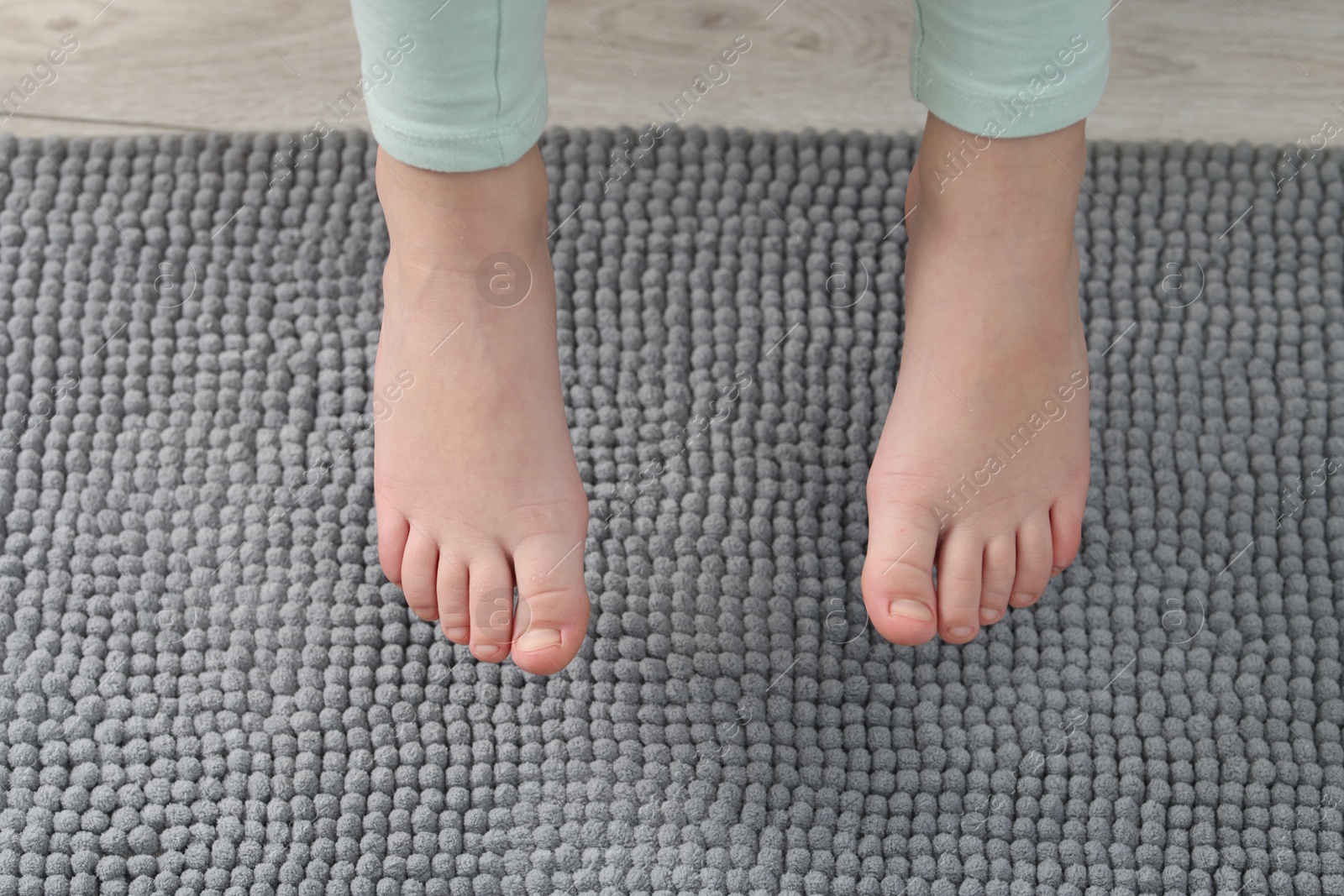 Girl above soft carpet at home, closeup Photo of Girl above soft carpet at home, closeup