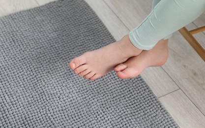 Photo of Girl above soft carpet at home, closeup. Space for text