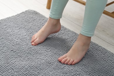 Photo of Girl on soft carpet at home, closeup. Space for text
