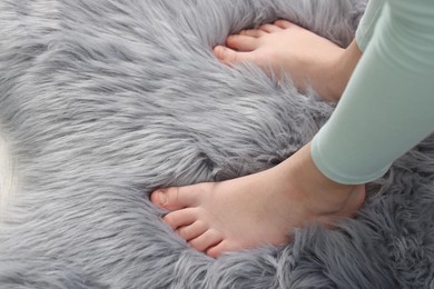 Photo of Girl on soft carpet at home, above view. Space for text