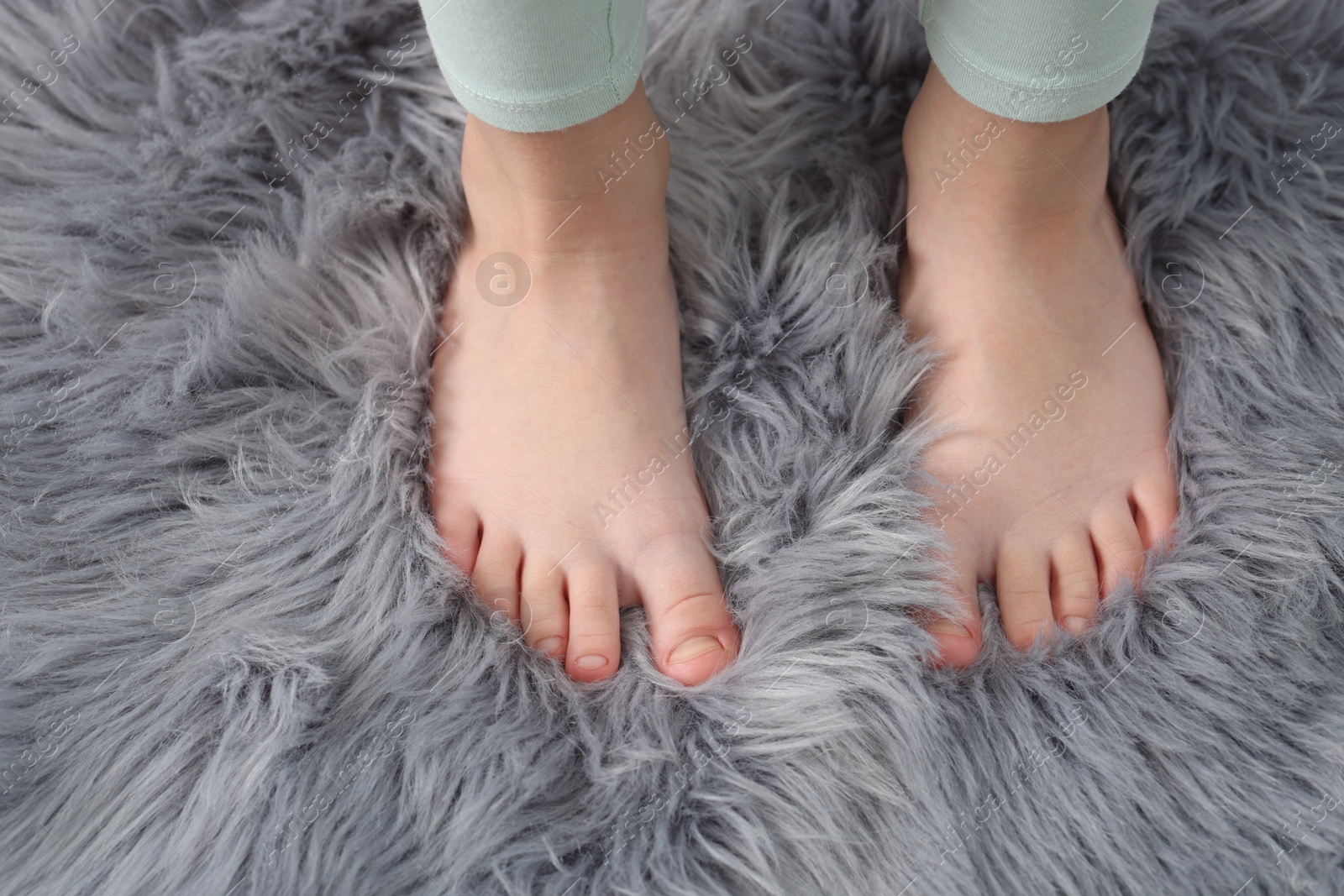 Girl on soft carpet at home, above view Photo of Girl on soft carpet at home, above view
