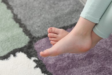 Photo of Girl above soft carpet at home, closeup. Space for text