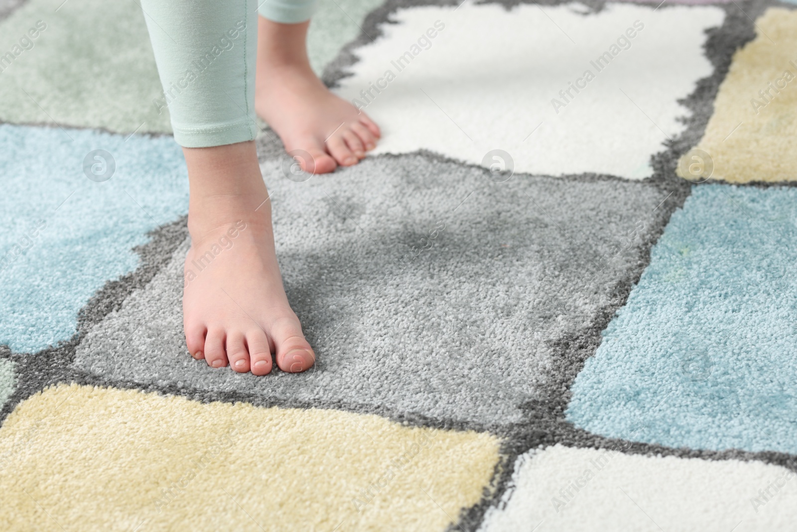 Girl on soft carpet at home, closeup. Space for text Photo of Girl on soft carpet at home, closeup. Space for text