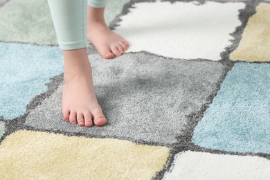 Photo of Girl on soft carpet at home, closeup. Space for text