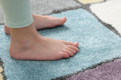 Photo of Girl on soft carpet at home, closeup
