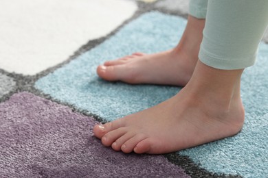 Photo of Girl on soft carpet at home, closeup