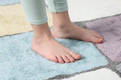 Photo of Girl on soft carpet at home, closeup