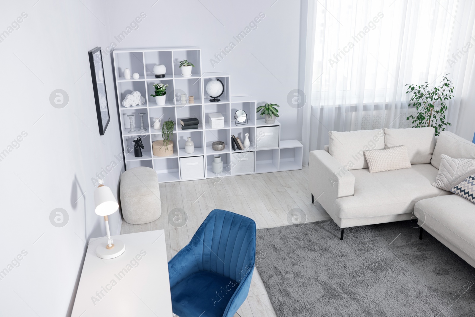 Comfortable sofa, shelving unit, table and armchair in living room, above view Photo of Comfortable sofa, shelving unit, table and armchair in living room, above view