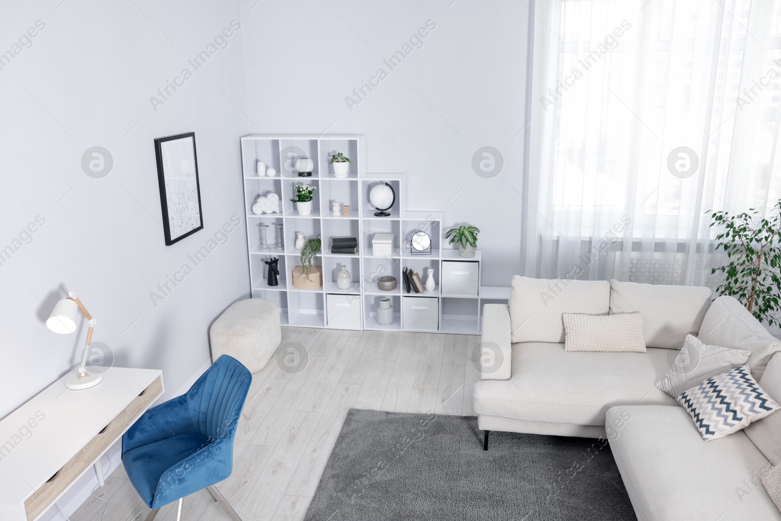Comfortable sofa, shelving unit, table and armchair in living room, above view Photo of Comfortable sofa, shelving unit, table and armchair in living room, above view