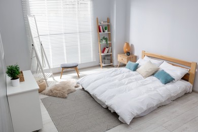 Photo of Comfortable bed, dresser and mirror in bedroom