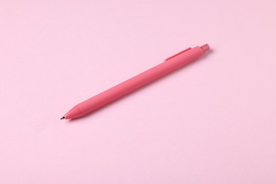Photo of One stylish pen on pink background, above view