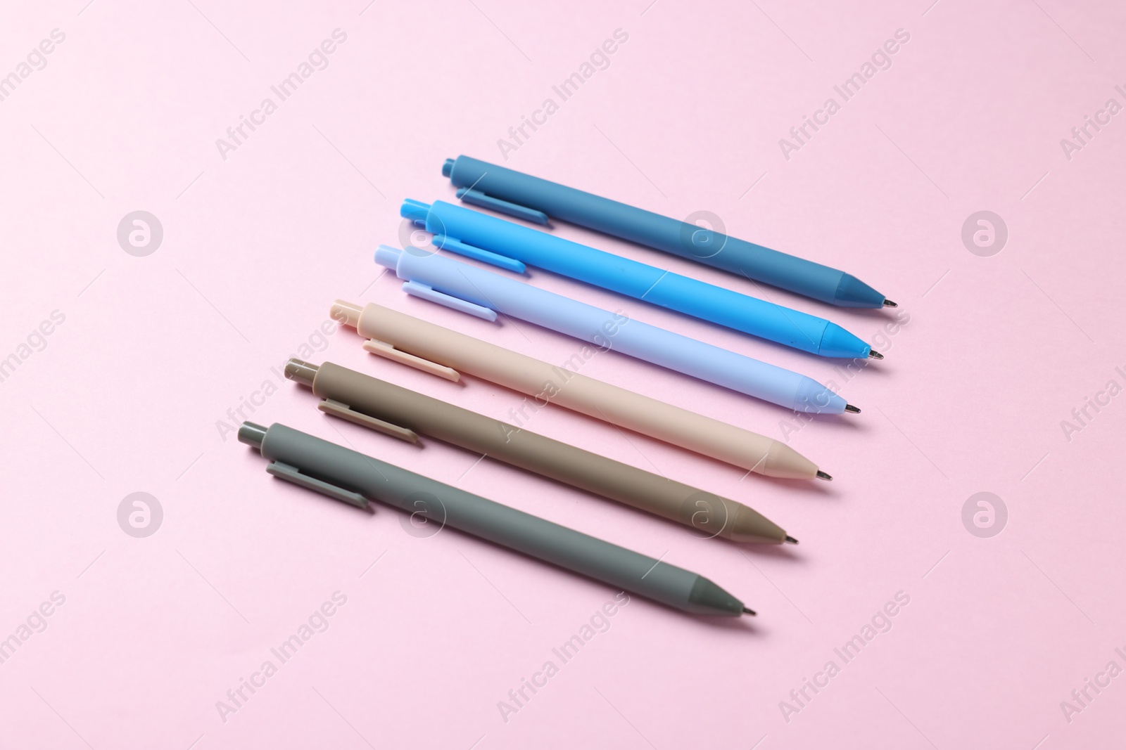 Set of ballpoint pens on pink background Photo of Set of ballpoint pens on pink background