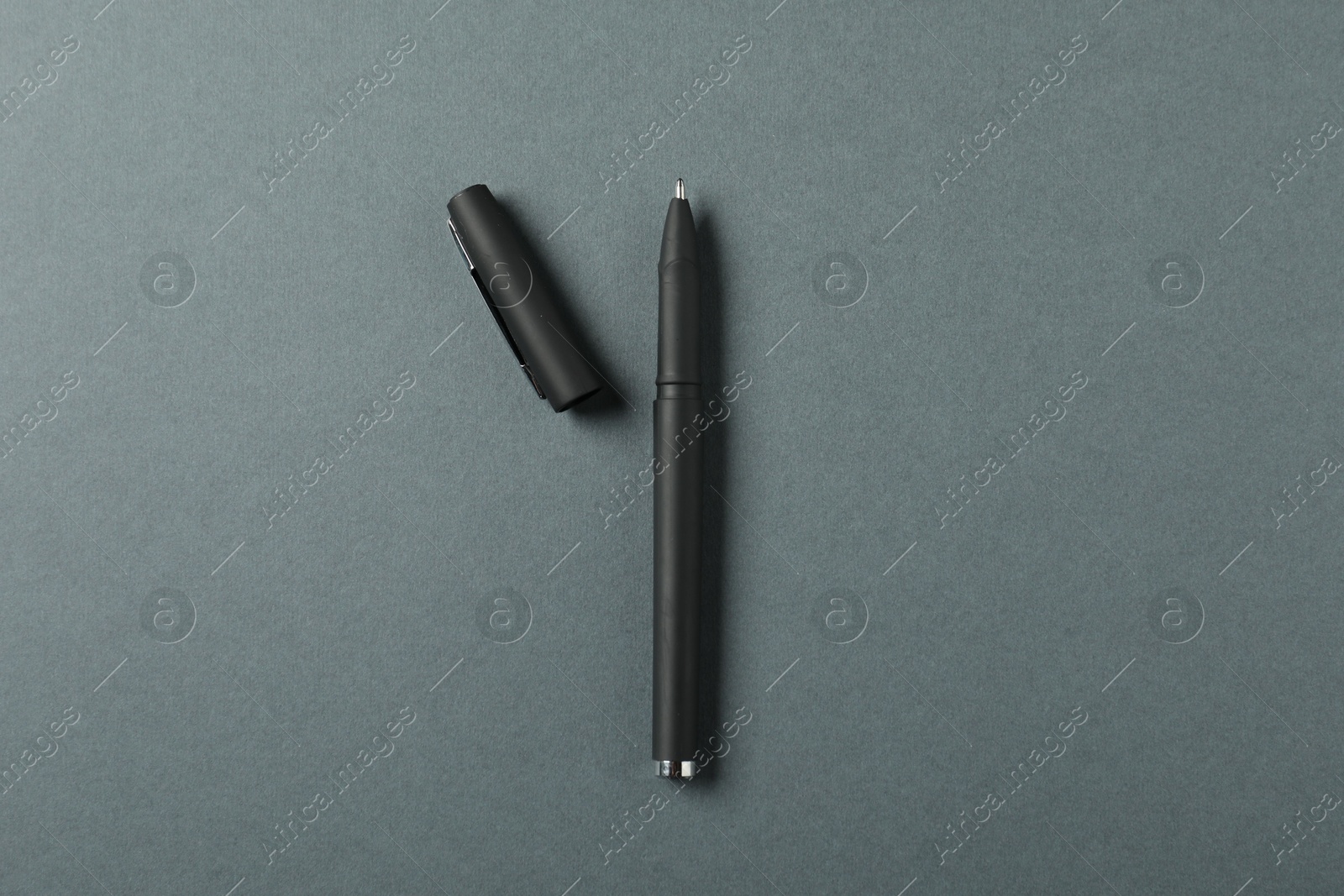 One stylish pen and lid on grey background, top view Photo of One stylish pen and lid on grey background, top view