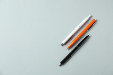 Photo of Stylish pens on grey background, flat lay. Space for text