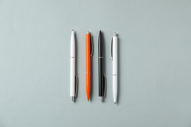 Photo of Stylish pens on grey background, flat lay