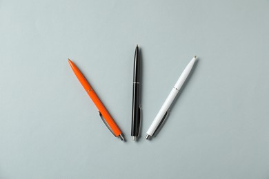 Photo of Stylish pens on grey background, flat lay