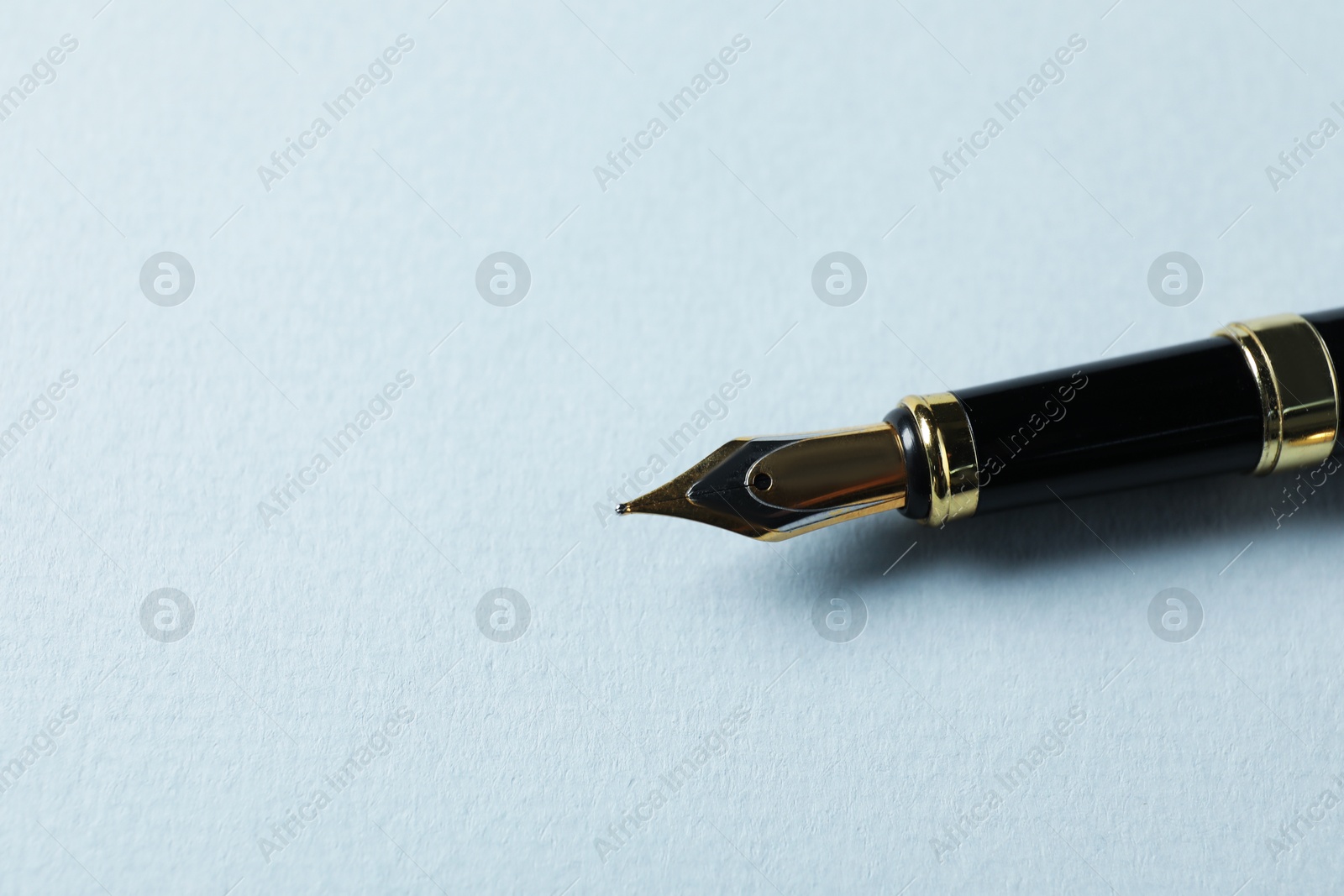 One stylish fountain pen on grey background, closeup. Space for text Photo of One stylish fountain pen on grey background, closeup. Space for text
