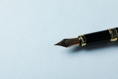 Photo of One stylish fountain pen on grey background, closeup. Space for text