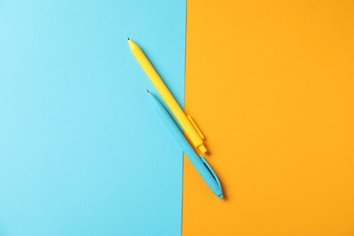 Photo of Stylish pens on color background, flat lay