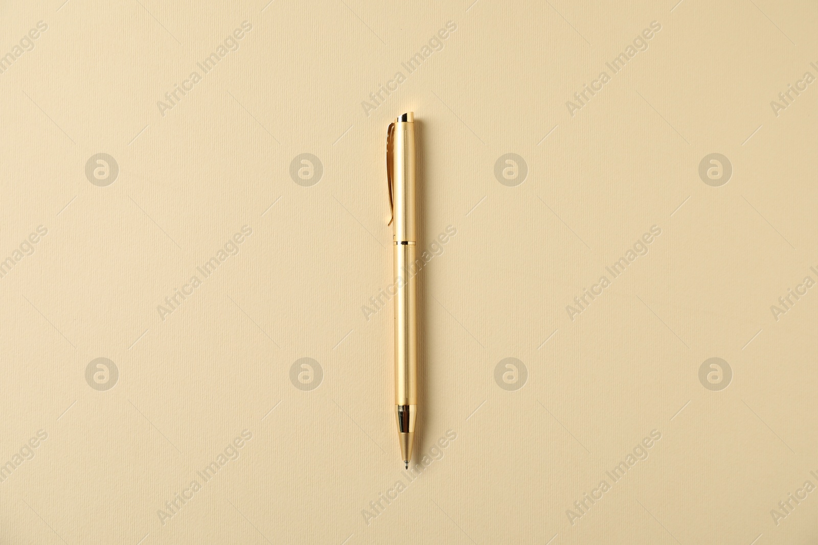 One stylish pen on beige background, top view Photo of One stylish pen on beige background, top view