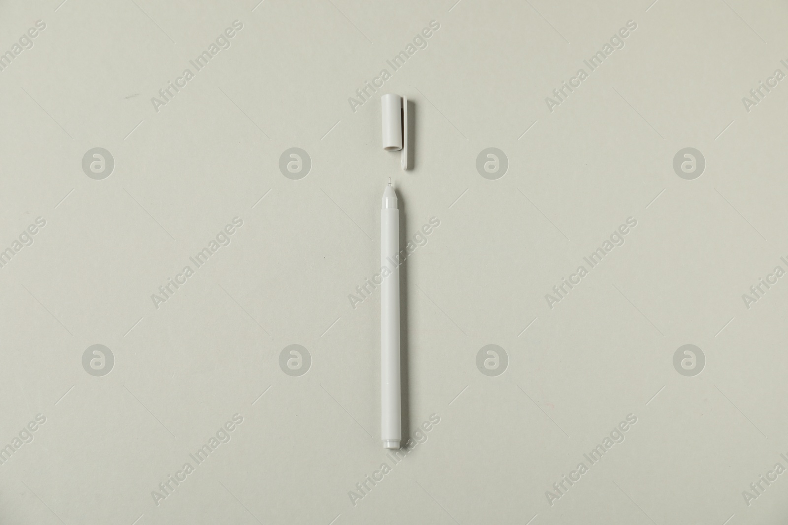 One stylish pen and lid on grey background, top view Photo of One stylish pen and lid on grey background, top view