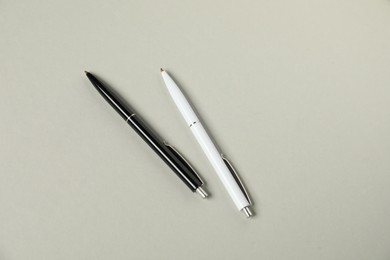 Photo of Stylish pens on grey background, flat lay