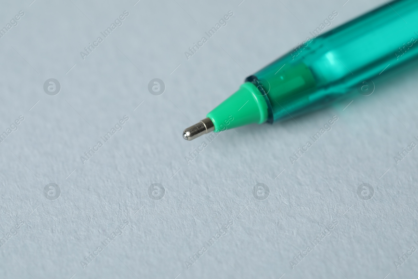 One ballpoint pen on grey background, macro view. Space for text Photo of One ballpoint pen on grey background, macro view. Space for text