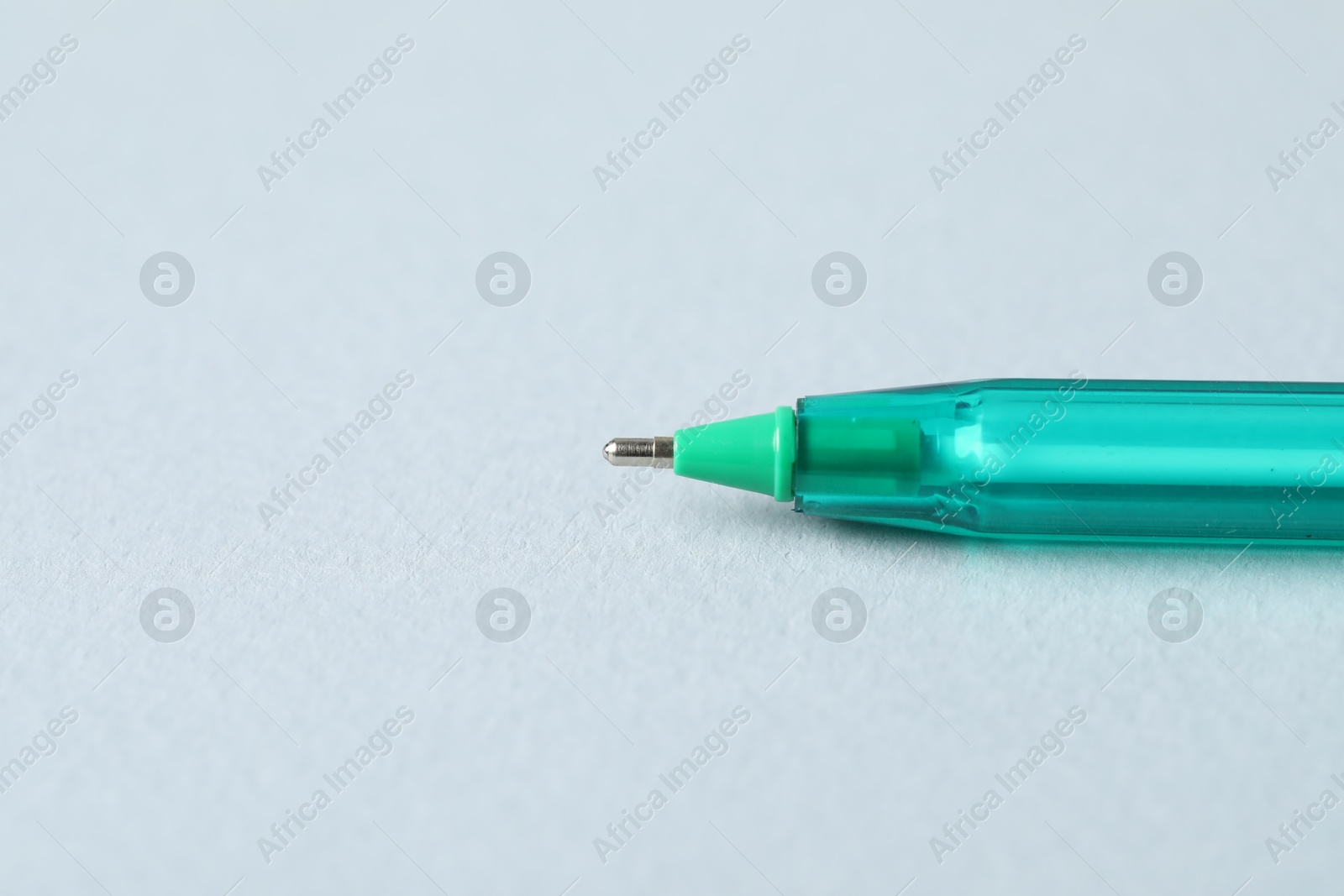 One ballpoint pen on grey background, macro view. Space for text Photo of One ballpoint pen on grey background, macro view. Space for text