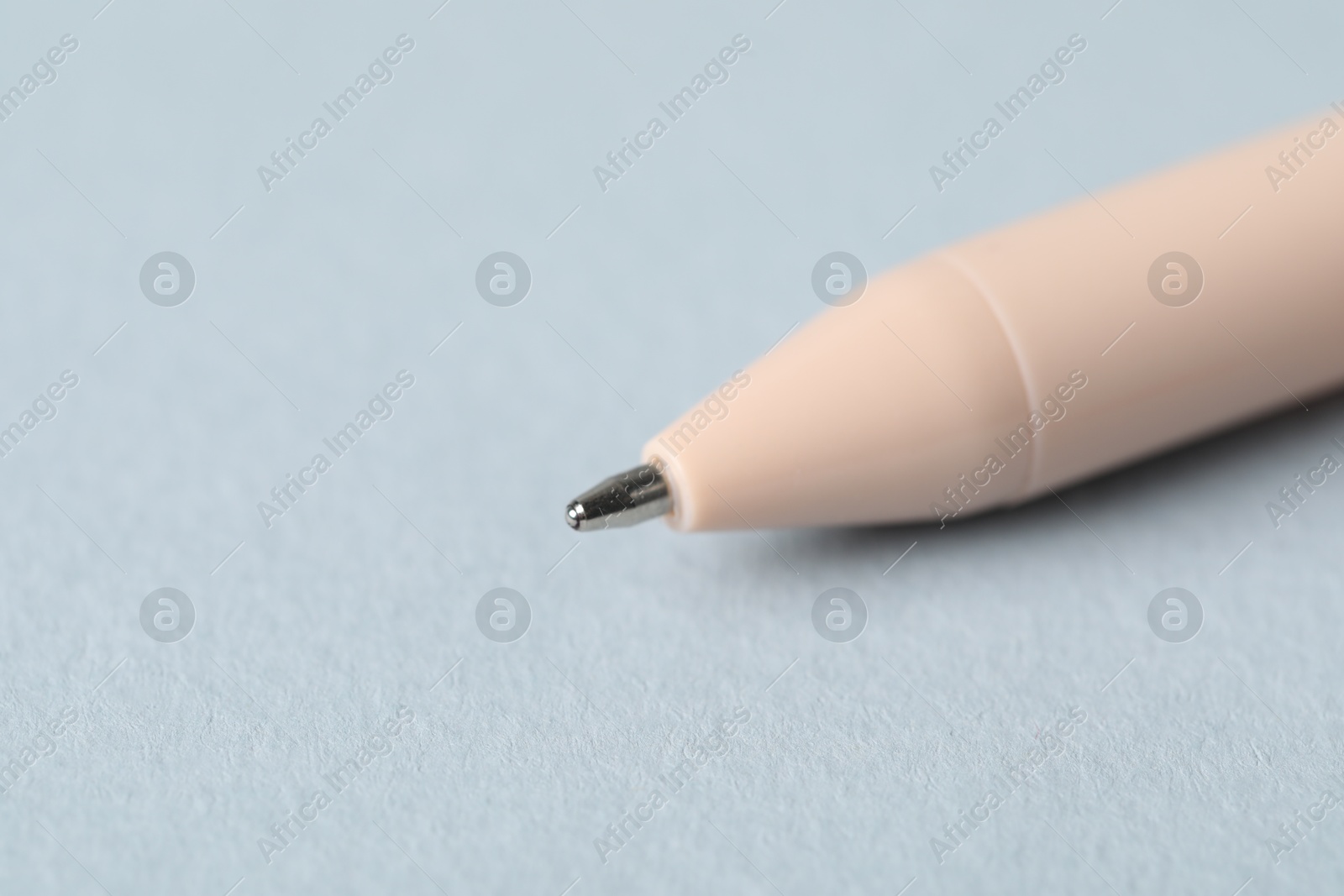 One ballpoint pen on grey background, macro view. Space for text Photo of One ballpoint pen on grey background, macro view. Space for text