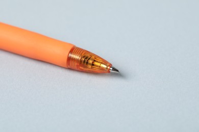 Photo of One ballpoint pen on grey background, macro view. Space for text
