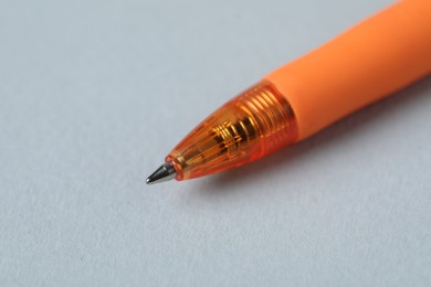Photo of One ballpoint pen on grey background, macro view. Space for text