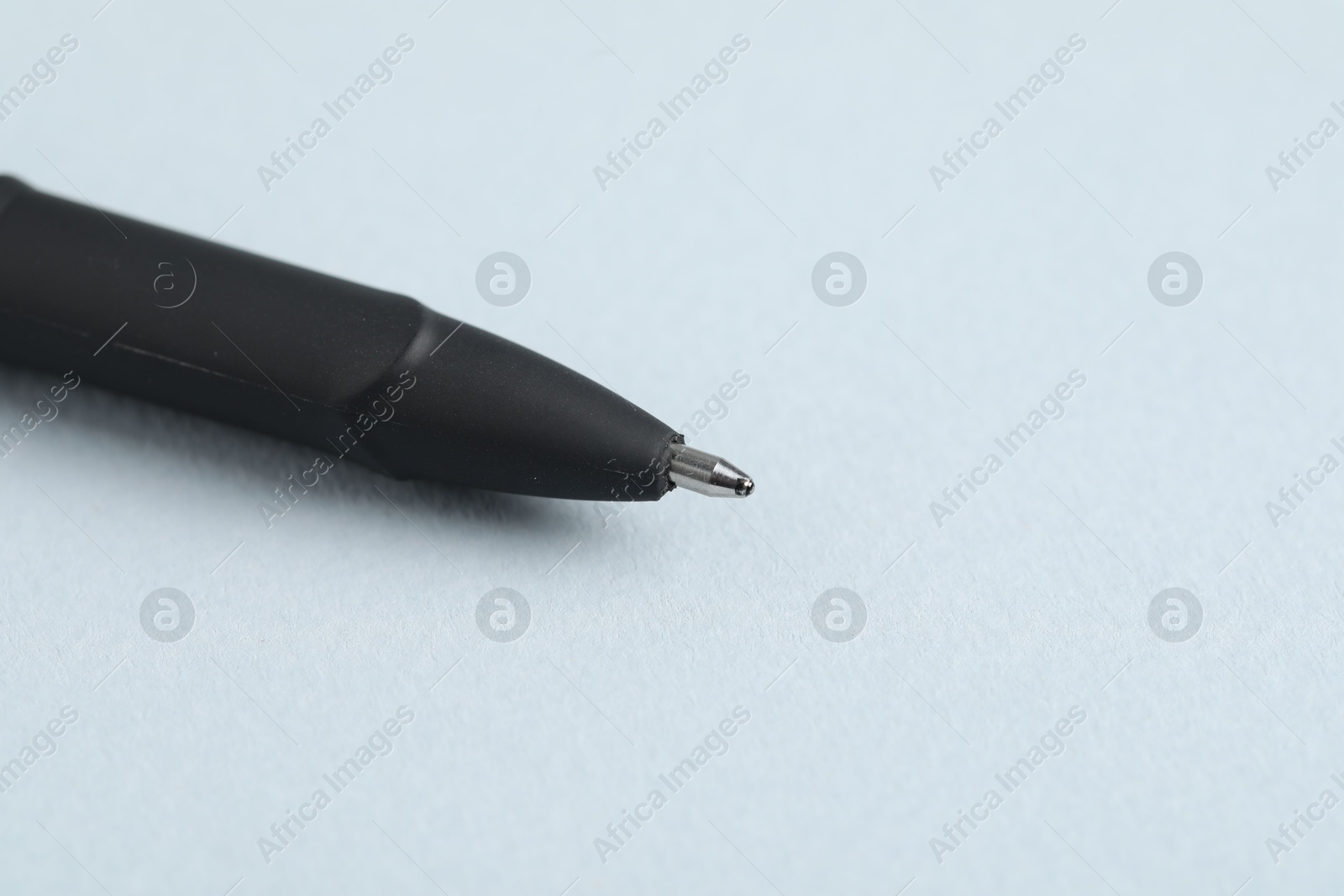 One ballpoint pen on grey background, macro view. Space for text Photo of One ballpoint pen on grey background, macro view. Space for text