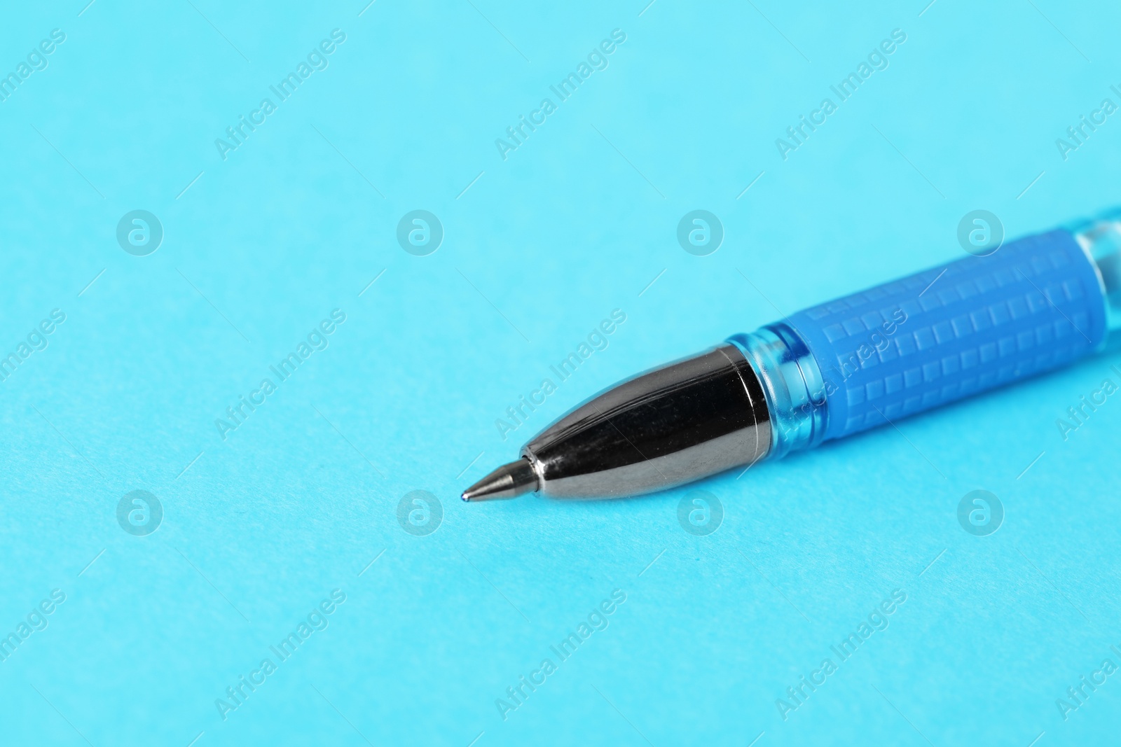 One ballpoint pen on light blue background, macro view. Space for text Photo of One ballpoint pen on light blue background, macro view. Space for text