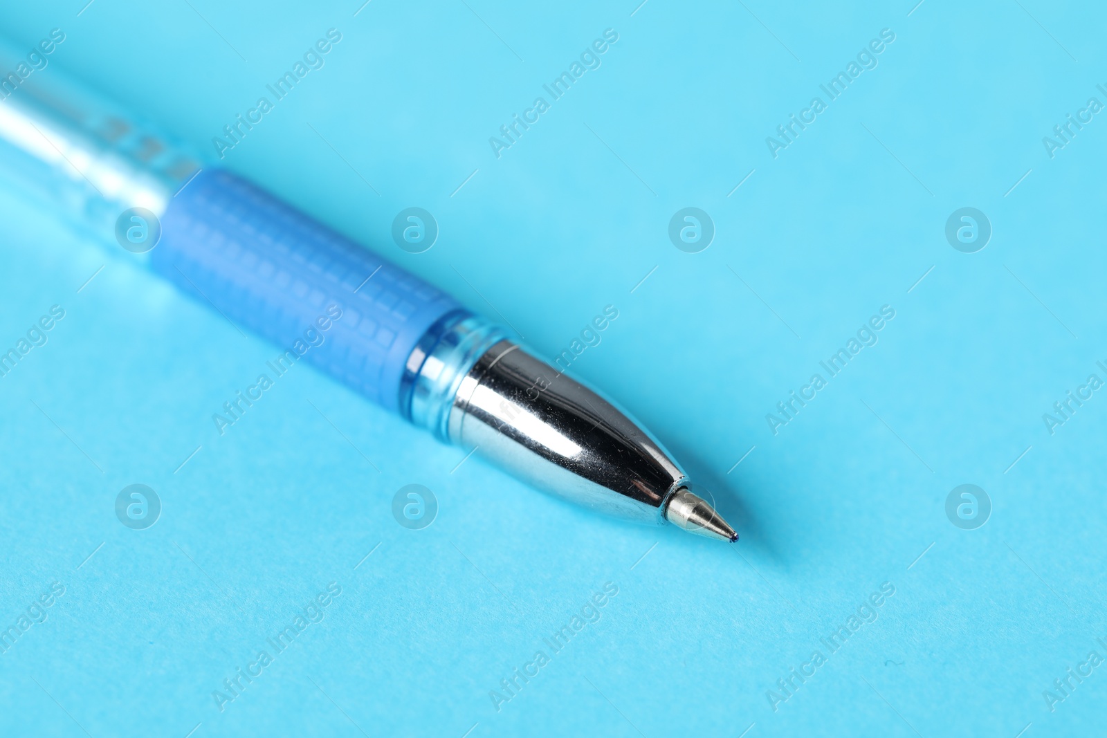 One ballpoint pen on light blue background, macro view. Space for text Photo of One ballpoint pen on light blue background, macro view. Space for text