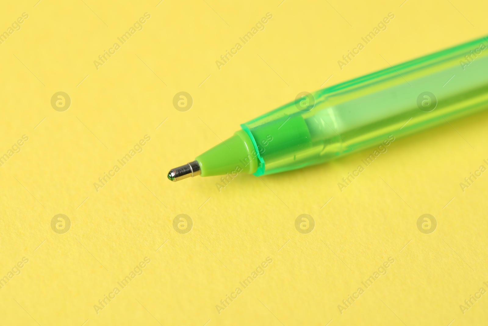 One ballpoint pen on yellow background, macro view. Space for text Photo of One ballpoint pen on yellow background, macro view. Space for text