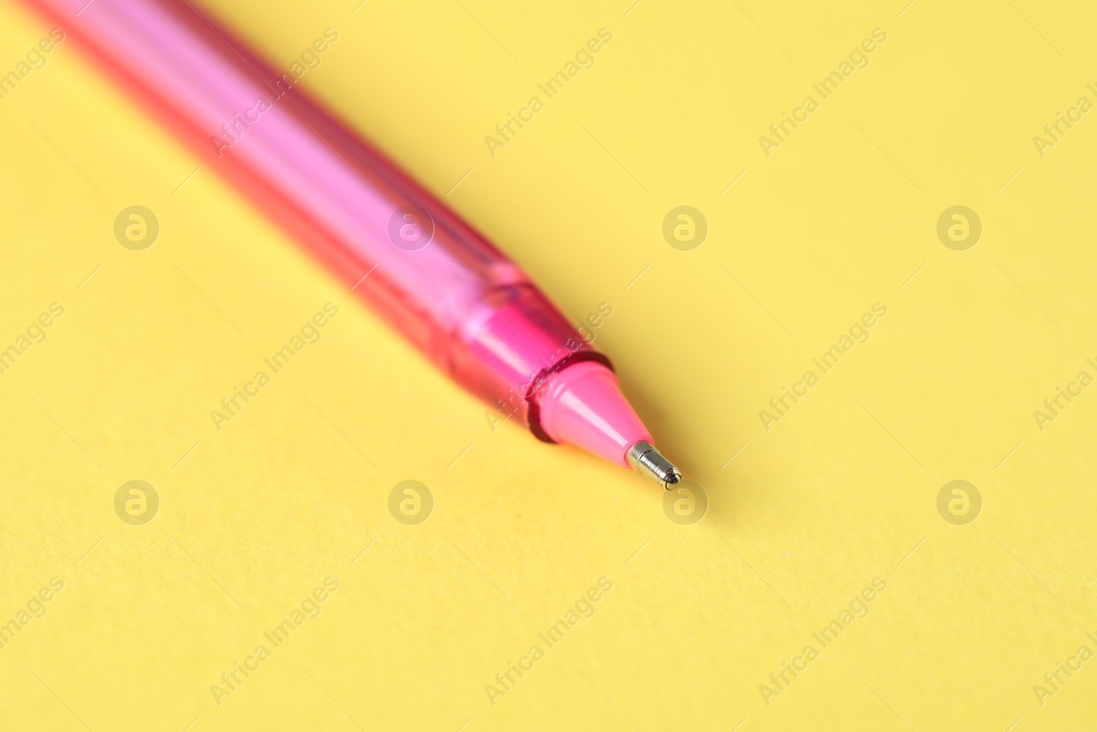 One ballpoint pen on yellow background, macro view. Space for text Photo of One ballpoint pen on yellow background, macro view. Space for text