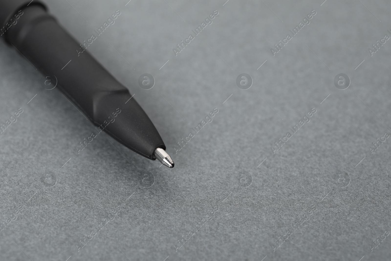 One stylish pen on grey background, macro view. Space for text Photo of One stylish pen on grey background, macro view. Space for text
