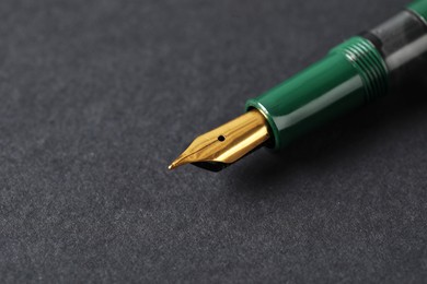 Photo of One fountain pen on dark background, macro view. Space for text