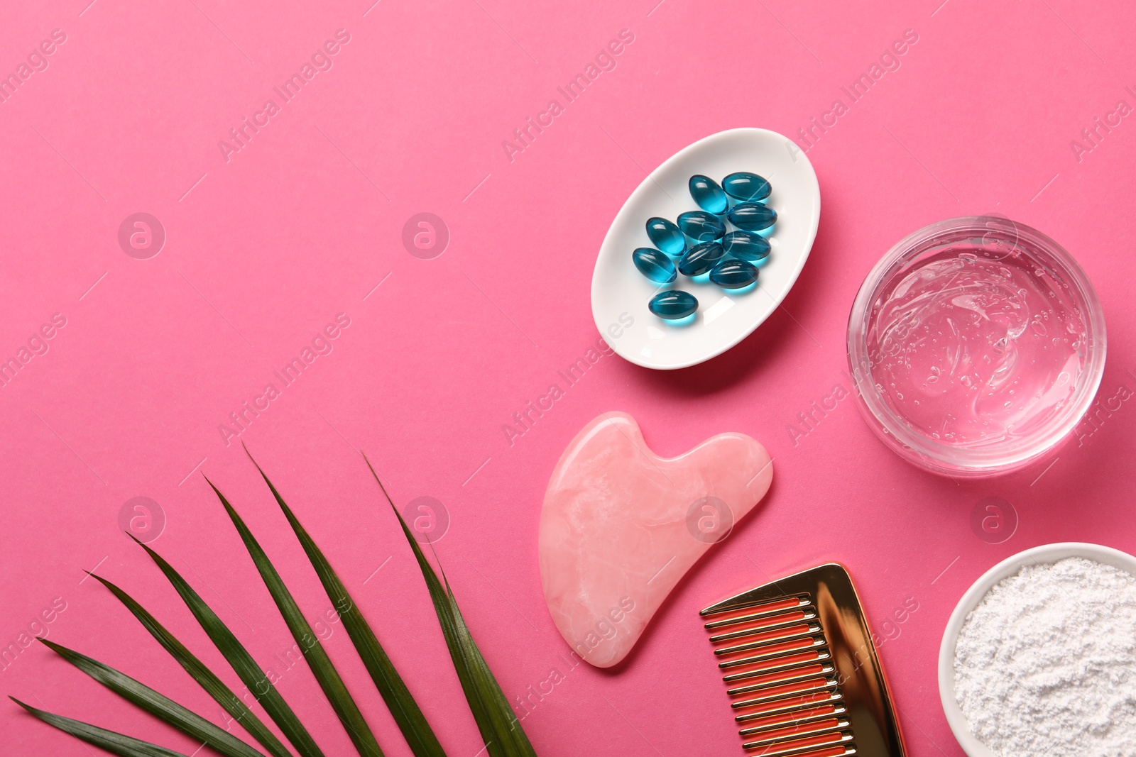 Collagen capsules, powder, gel, comb and gua sha on pink background, flat lay. Space for text Photo of Collagen capsules, powder, gel, comb and gua sha on pink background, flat lay. Space for text