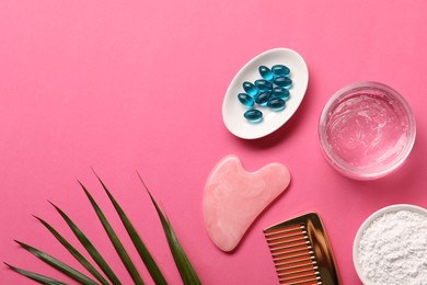 Photo of Collagen capsules, powder, gel, comb and gua sha on pink background, flat lay. Space for text