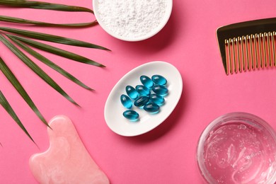 Photo of Collagen capsules, powder, gel, comb and gua sha on pink background, flat lay