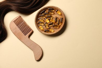 Photo of Collagen capsules, hair lock and comb on beige background, flat lay. Space for text