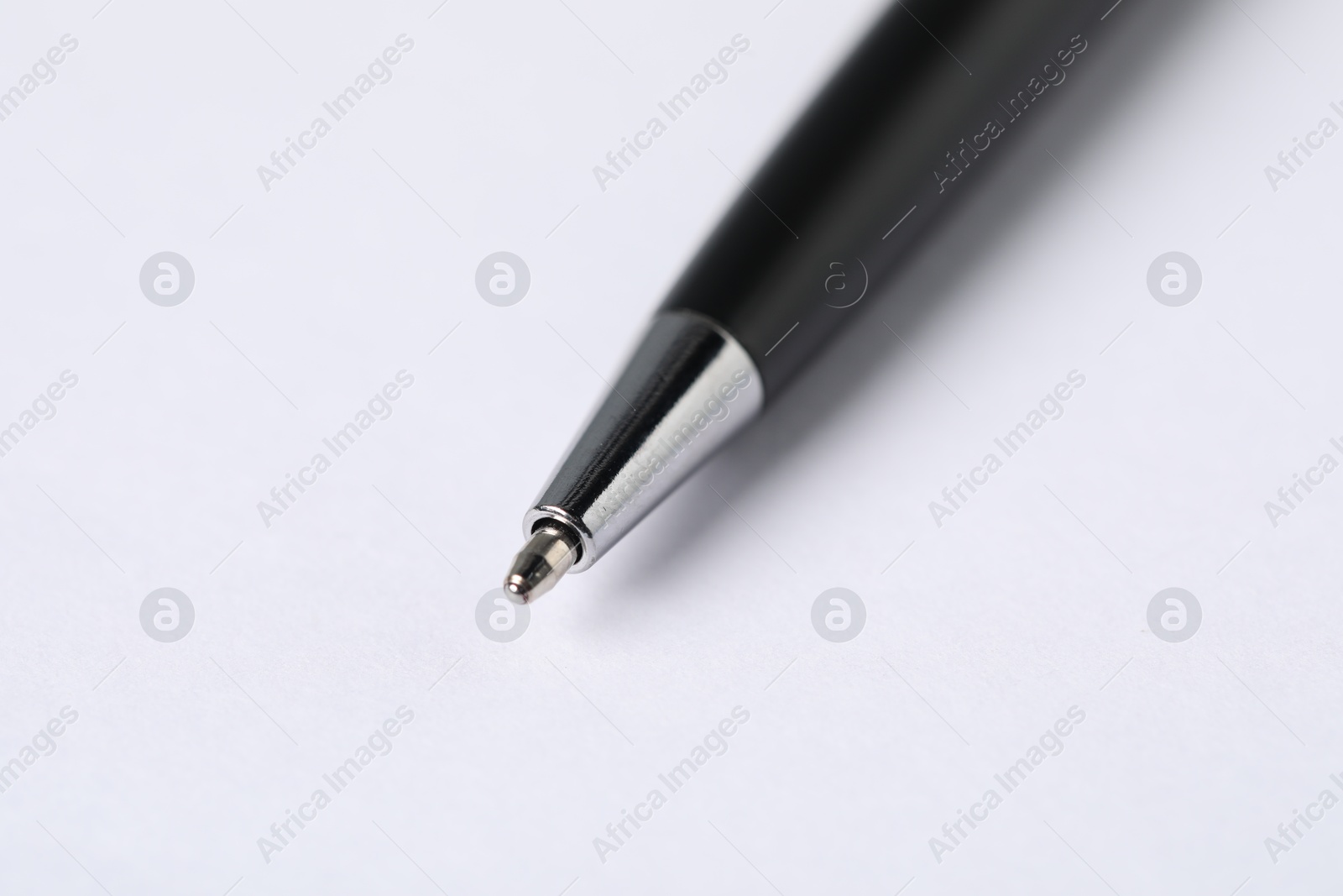 One stylish pen on light background, macro view Photo of One stylish pen on light background, macro view