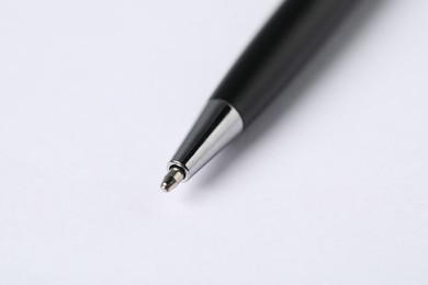 Photo of One stylish pen on light background, macro view