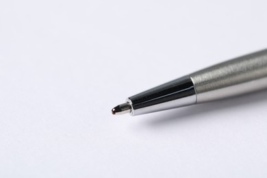 Photo of One stylish pen on light background, macro view. Space for text